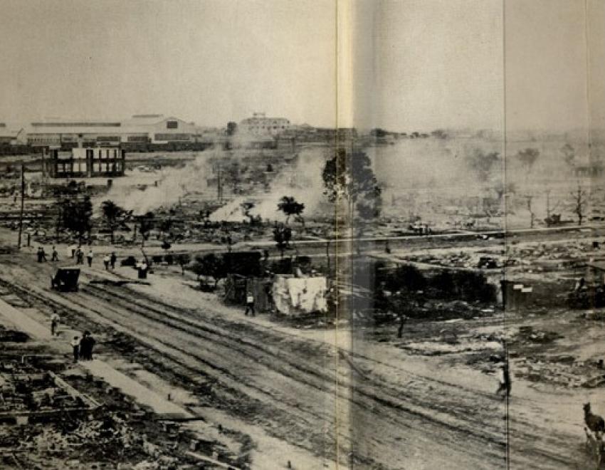 Taken from the southeast corner of the roof of Booker T. Washington High School, this panorama shows much of the damage within a day or so of the riot and the burning.  The road running laterally through the center of the image is Greenwood Avenue, the road slanting from the center to the left is Easton, and the road slanting off to the right is Frankfort.