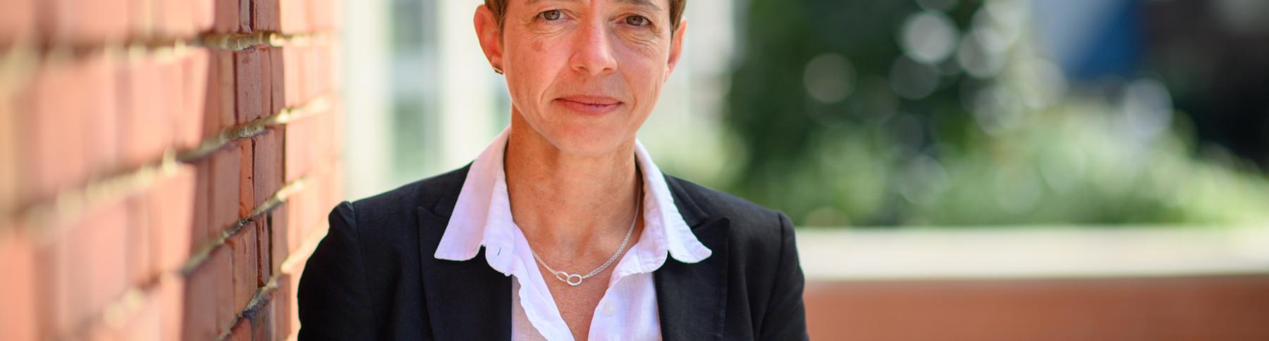 Woman in black suite with white shirt