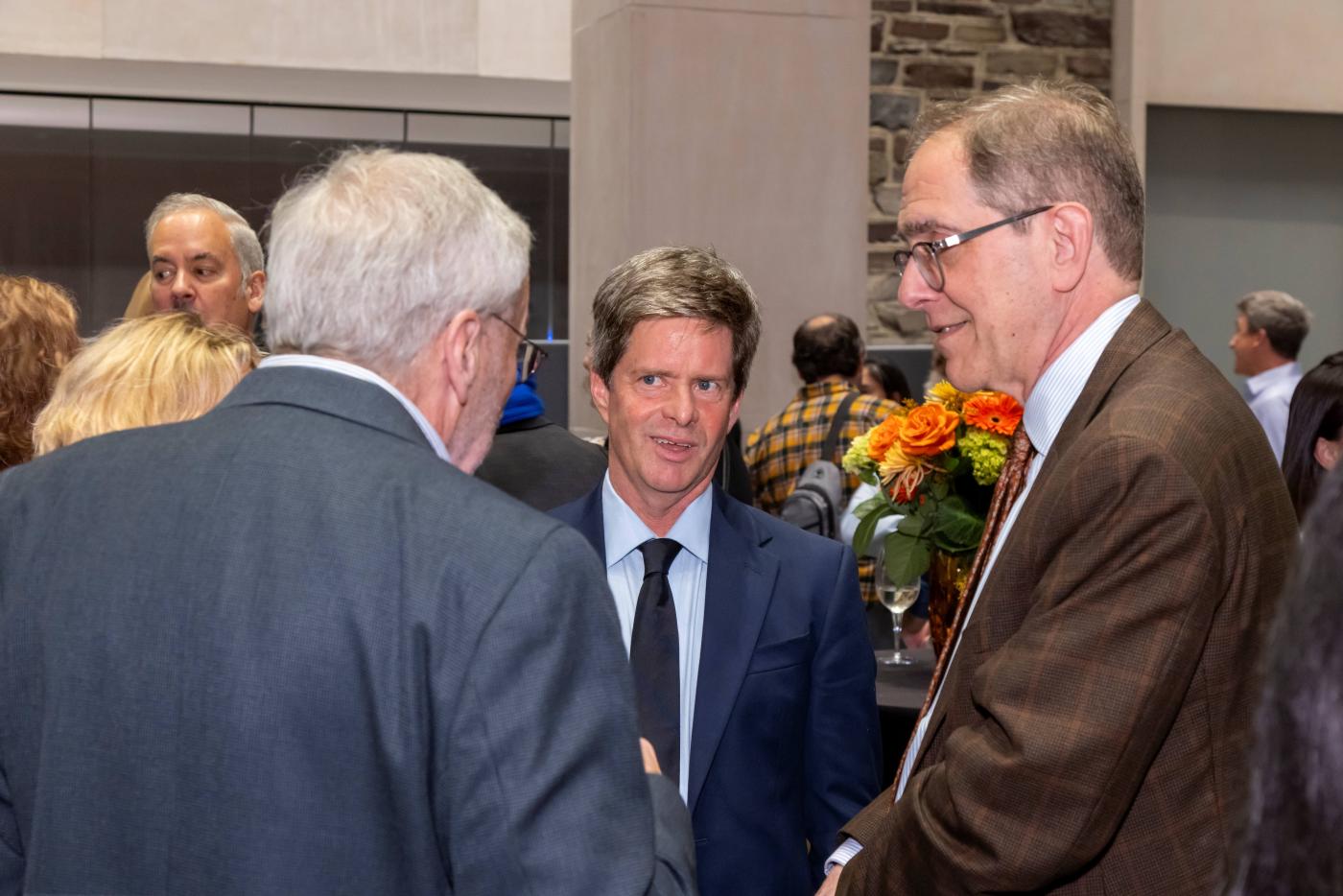 University President Eisgruber speaks with Professors Patten and Beitz at celebration