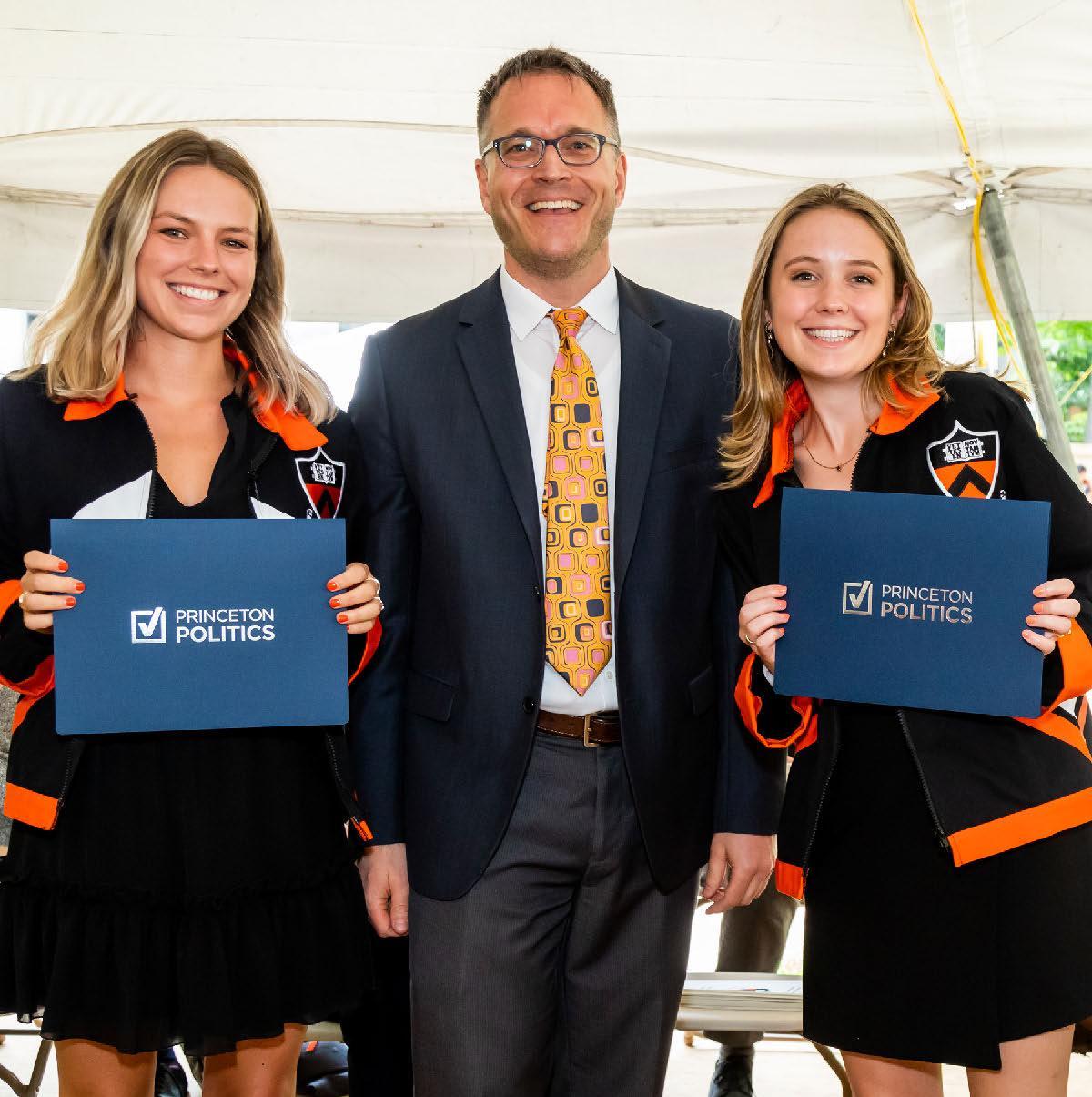 Professor Markus Prior standing with two award winning undergraduate students