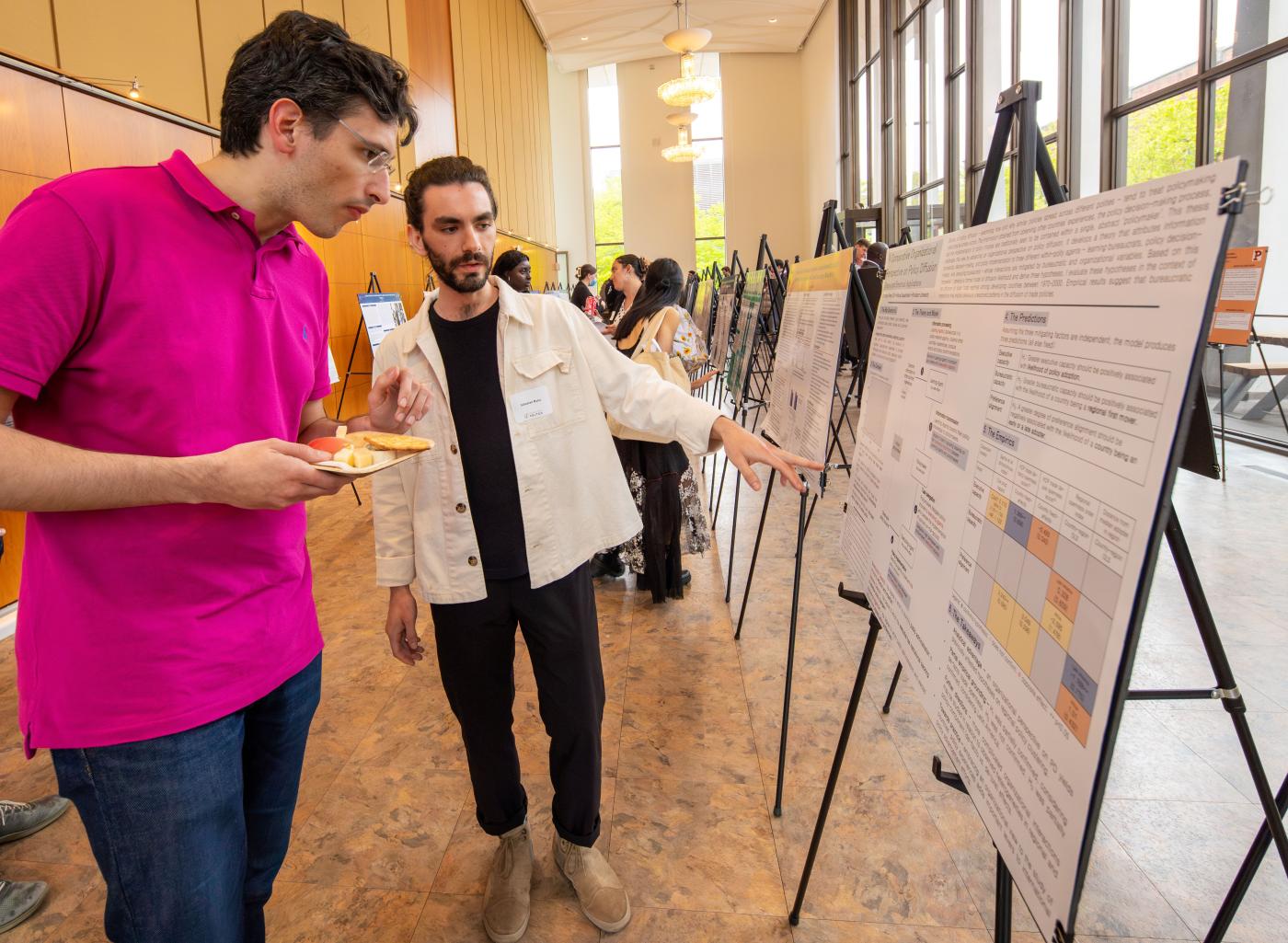 Professor and student looking at research poster