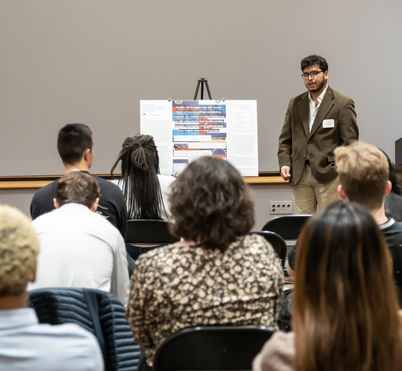 student presenting poster 