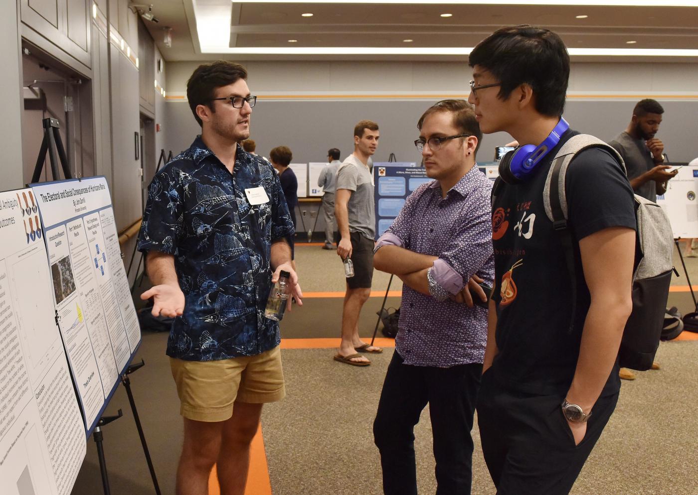 Photo of three students at senior thesis research poster session