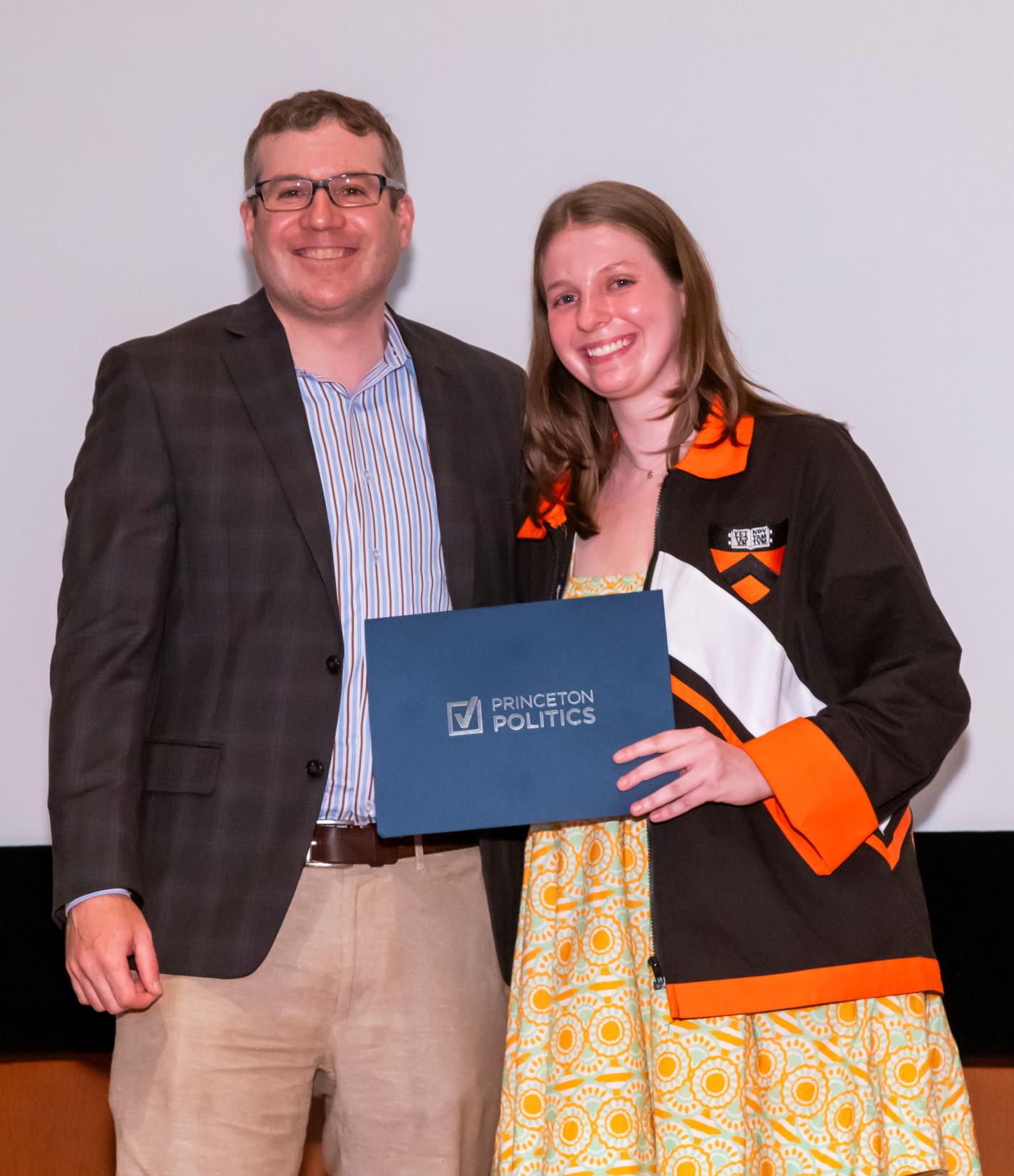 Professor Kastellec stands with award winning student.