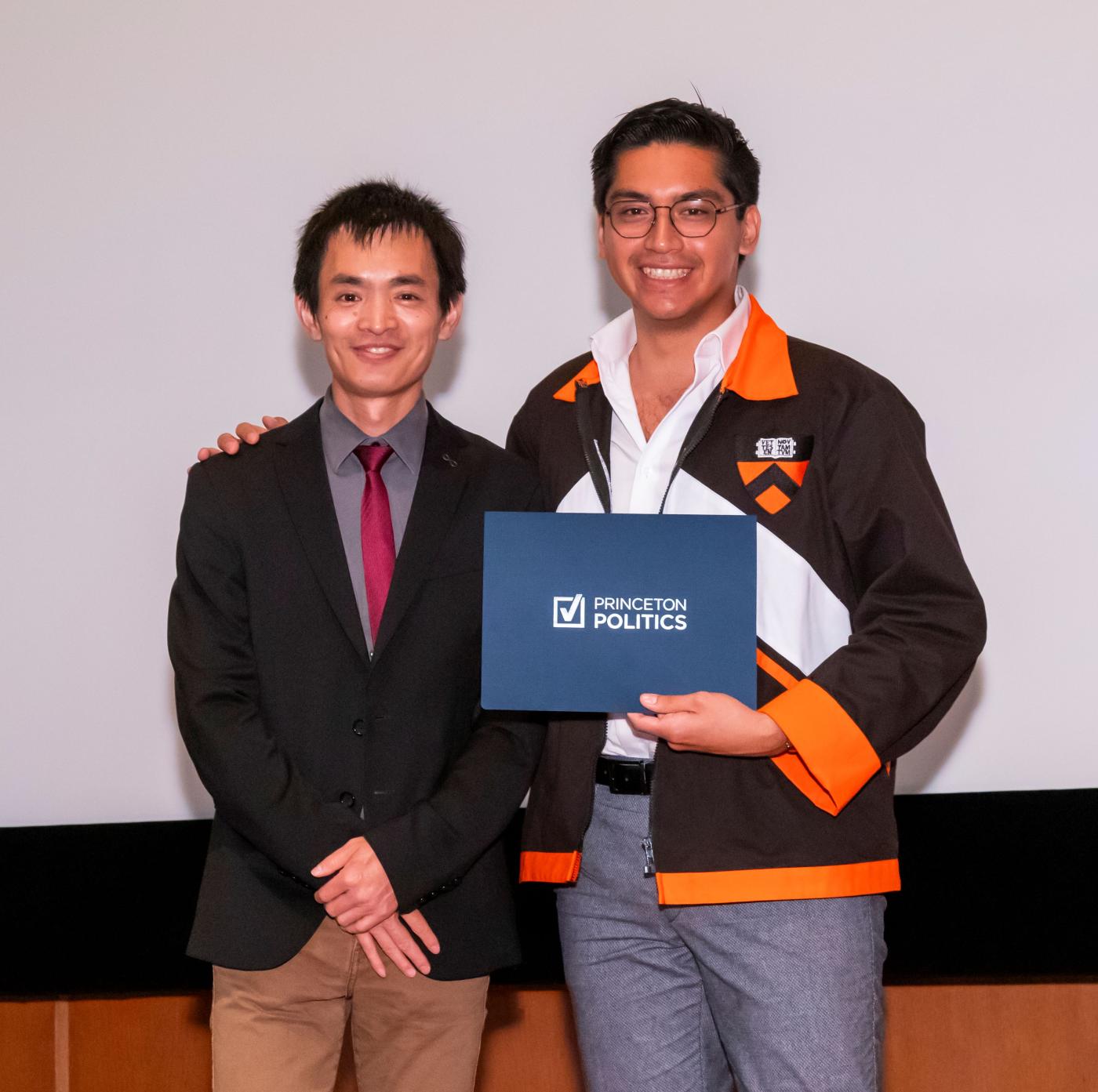 Professor Xu Xu stands with an award winning student