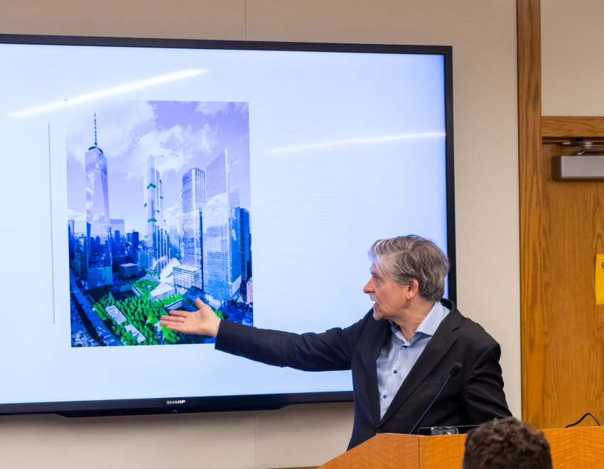 Professor Jan-Werner Müller pointing to a photo of the proposed design for Ground Zero in front of a class